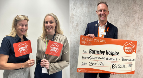 Colleagues holding a big cheque and Barnsley Hospice merchandise. 